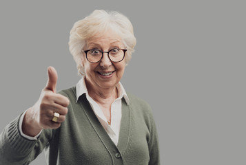 Cheerful senior lady giving a thumbs up