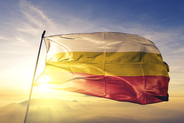 Santa Isabel municipality of Puerto Rico flag waving on the top sunrise mist fog