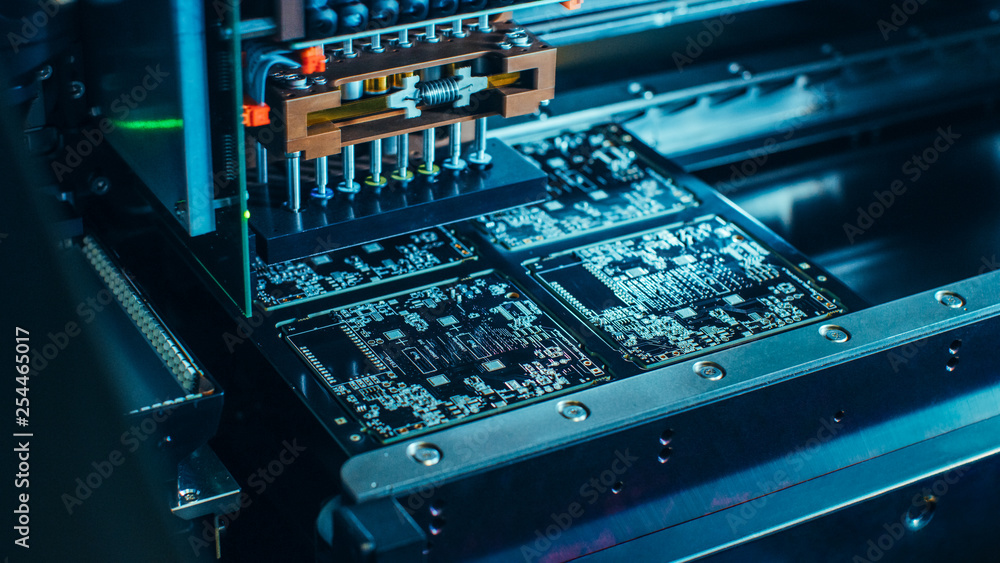 Poster factory machine at work: printed circuit board being assembled with automated robotic arm, surface m