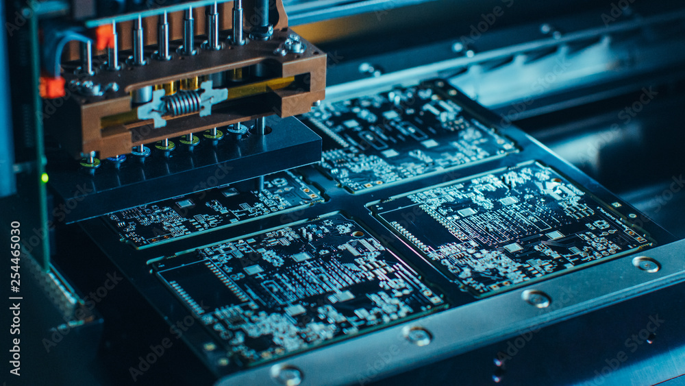 Poster close-up macro shot of electronic printed circuit board being assembled with automated robotic arm, 