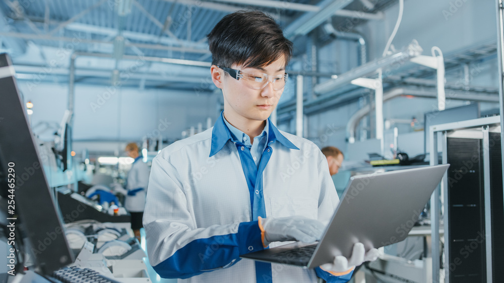 Poster on high-tech factory asian engineer uses laptop computer for programing pick and place electronic ma