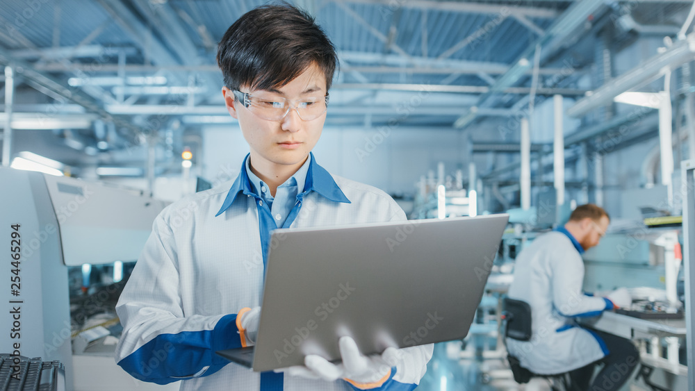 Poster on high-tech factory asian engineer uses laptop computer for programing pick and place electronic ma