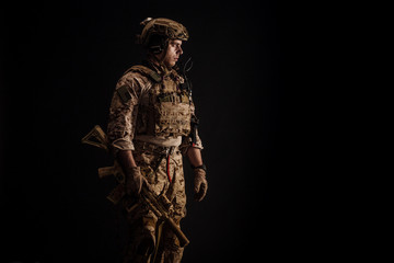 Special forces United States soldier or private military contractor holding rifle. Image on a black background. war, army and people concept