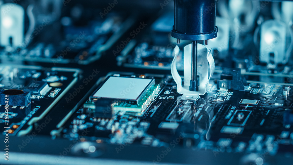Poster close-up macro shot of electronic factory machine at work: printed circuit board being assembled wit