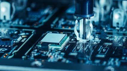 Close-up Macro Shot of Electronic Factory Machine at Work: Printed Circuit Board Being Assembled...