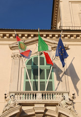 Italian flags with the symbol of the Republic and above the entr