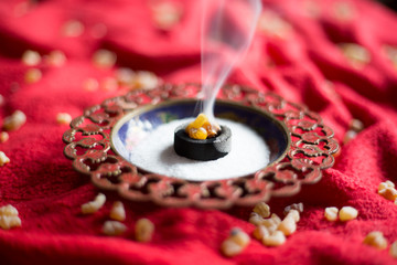Frankincense burning on a hot coal. Frankincense is an aromatic resin, used for religious rites, incense and perfumes, incense smoke - obrazy, fototapety, plakaty