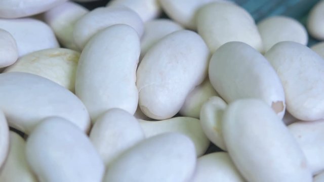 Close-up white beans on the wooden table, ready to cooking