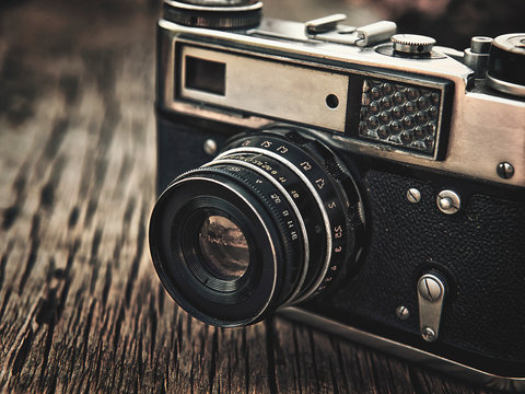 old vintage camera closeup on wooden background