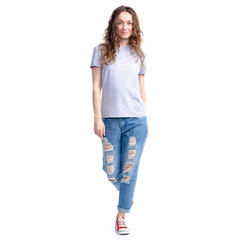 Obraz premium Woman in jeans walking in move looking on white background isolation