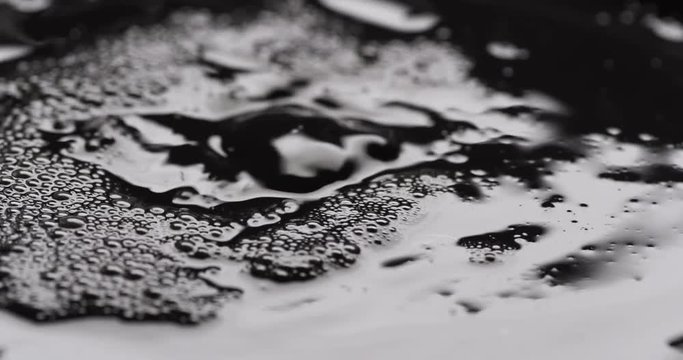Clear liquid flowing into foul foamy and bubbly substance