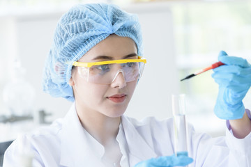 Asian young girl student scientist researching  and learning in a laboratory.