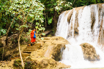 A monk on a mountain waterfall "Taj Ka". Laos.