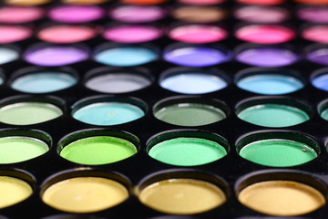 Different tonic green, light blue and purple make-up powder. 