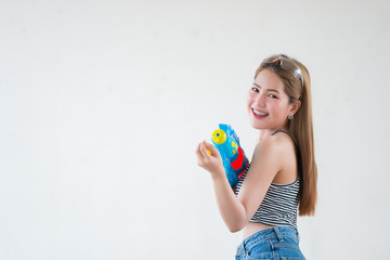 Asian sexy woman with gun water in hand on white background,Festival songkran day at thailand,The best of festival of thai,Land of  smile