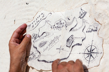 Male hands holding the old treasure map. My own hand made paint and don't need property release
