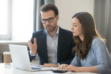 Fototapeta na wymiar Helpful boss mentor explaining new online project to worker intern