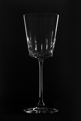Crystal empty wineglass on the black background