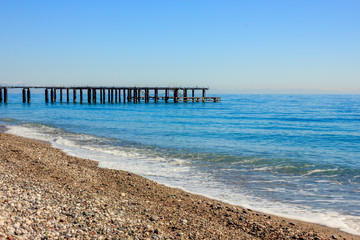 Mediterranean landscape in Antalya, Turkey. Blue sea, pier and mountains.