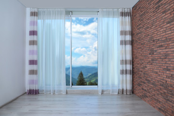 Beautiful view from new modern window with curtain in empty room