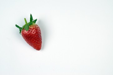 Fresh juicy strawberry with green leaves isolated at white background