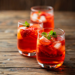 Fresh summer cocktail with ice, strawberry and mint