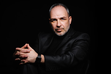 Studio portrait of a businessman in an expensive black suit