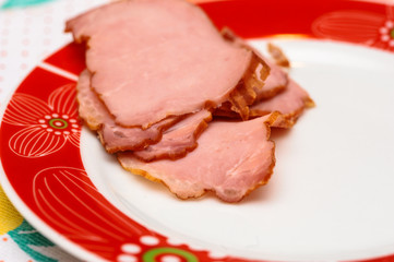 Plate with tasty sliced baked ham on table