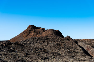 Timanfaya National Park, mountains of fire, Lanzarote, Canary Islands, Spain. Unique panoramic view of spectacular lava river flows from a huge volcano crater creates lunar landscape on planet earth.