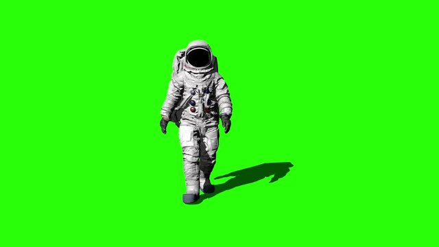 Astronaut walking on the Green Screen and saluting.
