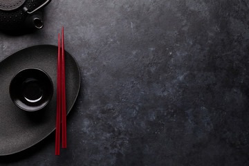 Empty plate, teapot and chopsticks