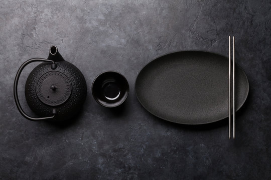 Empty plate, teapot and chopsticks