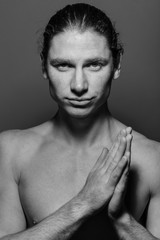 Portrait of a muscular long-haired man with drawn hair and freckles, topless