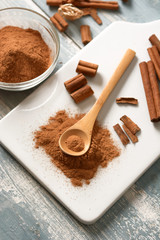 cinnamon powder on white cutting board