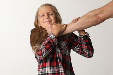 Portrait girl with long blond hair that chokes a male hand. White background