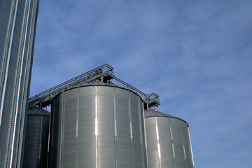 tanks in farm with blue sky and clouds,industry, storage, silo, tank, factory, metal, grain, sky, steel,industrial, agriculture, plant, 