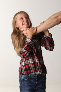 Portrait girl with long blond hair that chokes a male hand. White background