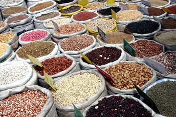 Various colorful spices in sacks on sale in the market