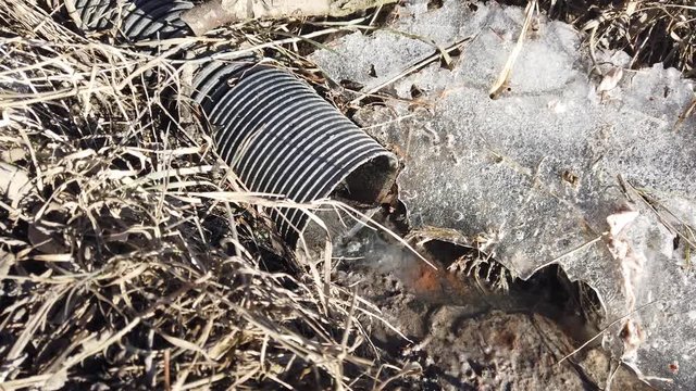 Drainpipe in nature on winter day.