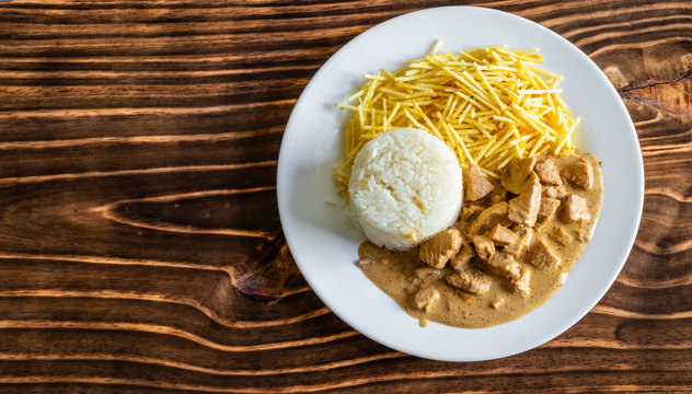Chicken stroganoff meal on wood, space for text