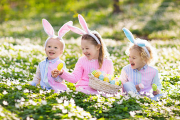 Kids with bunny ears on Easter egg hunt.