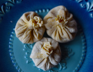 Fototapeta na wymiar dumplings khinkali boiled on a blue plate
