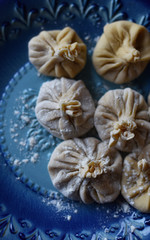 dumplings khinkali boiled on a blue plate