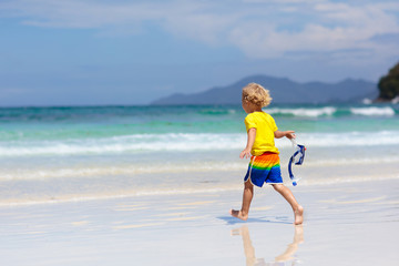 Child snorkeling on tropical beach. Kids snorkel.