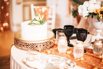 wedding cake with flowers.  Serving a Banquet table in black and gold color. Wedding decor