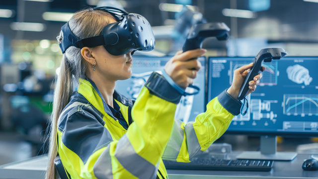 Female Industrial Engineer Wearing Virtual Reality Headset and Holding Controllers, She Uses VR technology for Industrial Design, Development and Prototyping in CAD Software.