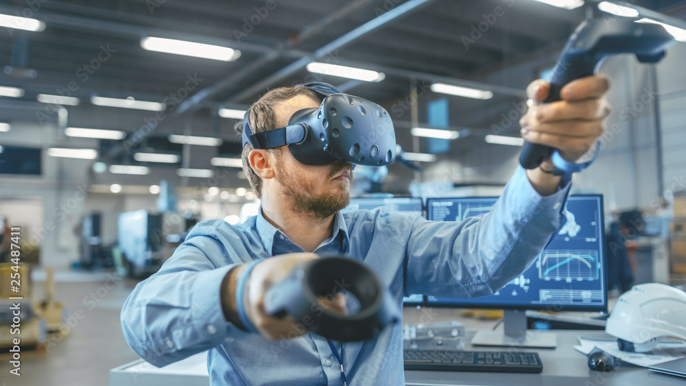 Poster portrait shot of the industrial engineer wearing virtual reality headset and using controllers, read