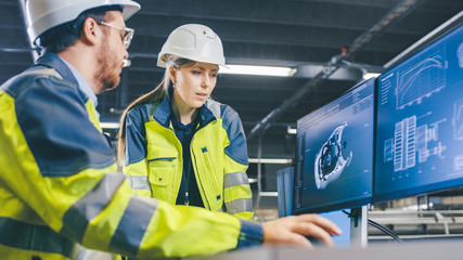 At the Factory: Male Mechanical Engineer and Female Chief Engineer Work Together on the Personal...