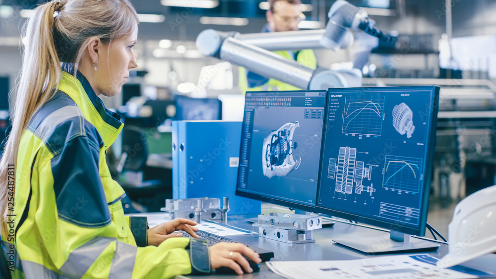 Poster At the Factory: Female Mechanical Engineer Designs 3D Engine on Her Personal Computer, Male Automation Engineer Uses Laptop for Programming Robotic Arm.
