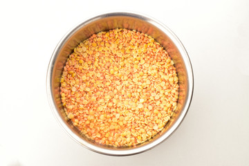 arhar and malka pulses with water in steel bowl isolated on whitw background